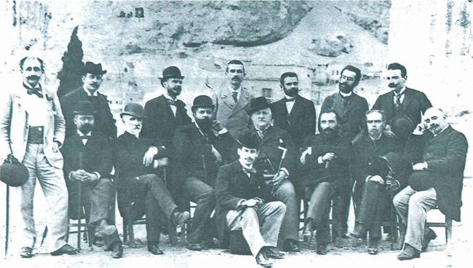 «Ο κύκλος της Εστίας». Από αριστερά, οι όρθιοι: Γιάννης Ψυχάρης, Δημήτριος Κακλαμάνος, Γεώργιος Κασδόνης, Γιάννης Βλαχογιάννης, Κωστής Παλαμάς, Γεώργιος Δροσίνης, Γρηγόριος Ξενόπουλος. Οι καθιστοί: Θεόδωρος Βελλιανίτης, Περρής, Νικόλαος Γ. Πολίτης, Στέφανος Στεφάνου, Μίκιος Λάμπρος, Γεώργιος Σουρής, Εμμανουήλ Ροΐδης, Εμμανουήλ Λυκούδης.